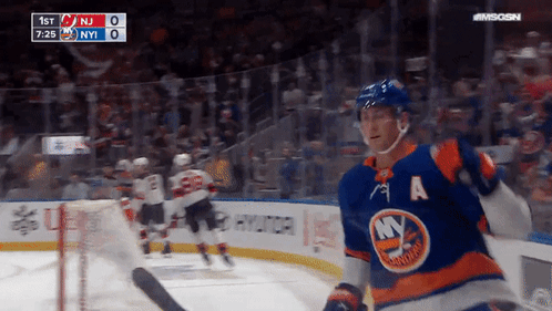 A Hockey Player With The Letter A On His Jersey Stands On The Ice GIF