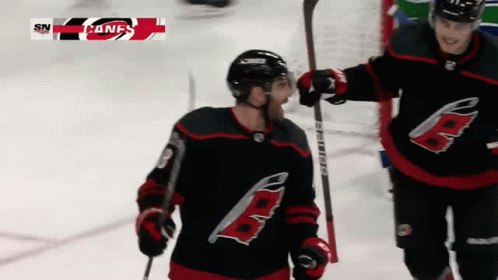 A Hockey Player With The Letter B On His Jersey Is Holding A Hockey Stick GIF