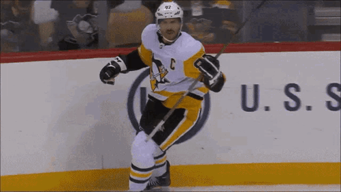A Hockey Player With The Letter C On His Jersey Is Holding A Stick GIF