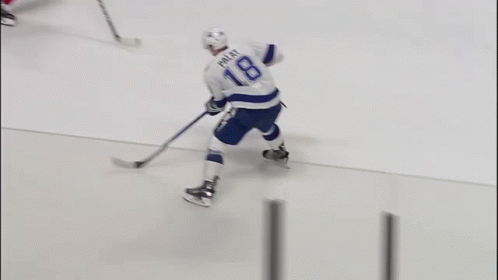 a hockey player with the name rice on his jersey is holding a hockey stick