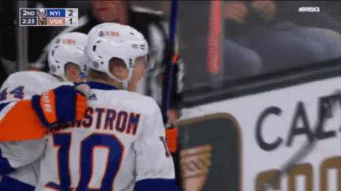 A Hockey Player With The Number 10 On His Back Is Hugging Another Player GIF