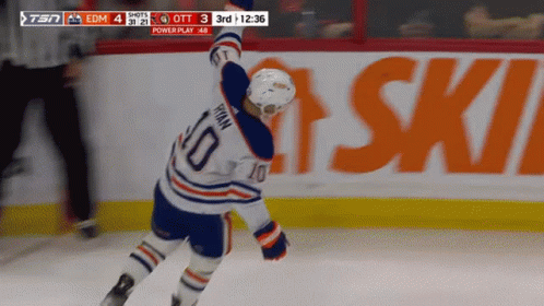 A Hockey Player With The Number 10 On His Jersey Stands On The Ice GIF