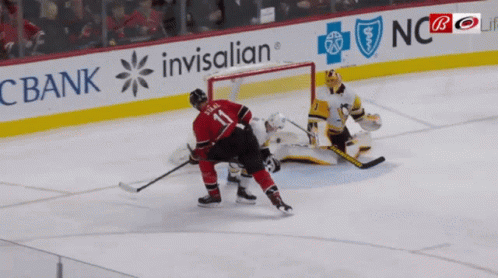 A Hockey Player With The Number 11 On His Back GIF