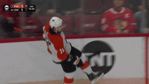 A Hockey Player With The Number 11 On His Jersey Is Skating On The Ice GIF