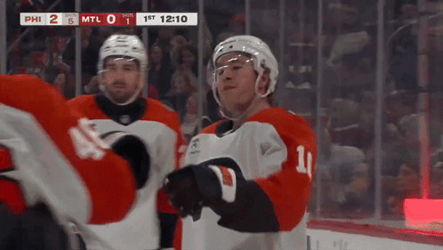 A Hockey Player With The Number 11 On His Jersey Stands On The Ice GIF