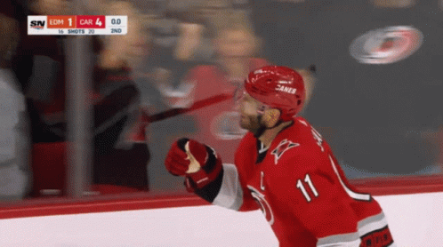 A Hockey Player With The Number 11 On His Shirt GIF