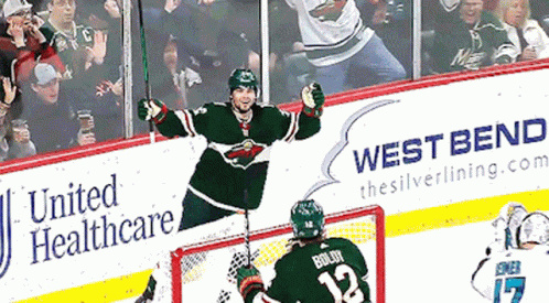 A Hockey Player With The Number 12 On His Jersey Celebrates GIF