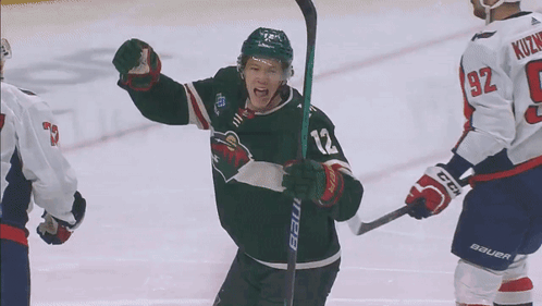 A Hockey Player With The Number 12 On His Jersey Is Celebrating GIF