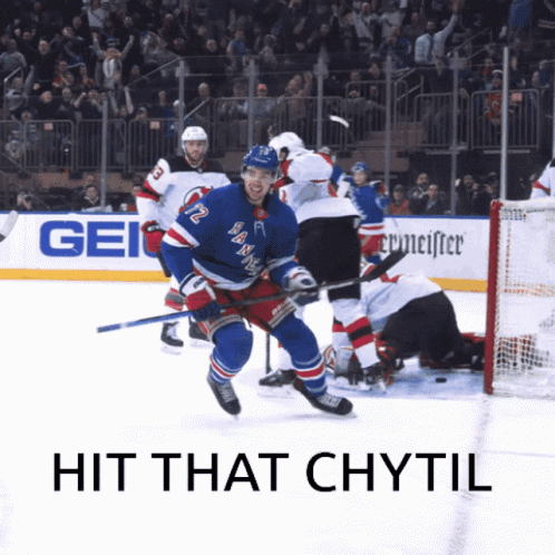 A Hockey Player With The Number 12 On His Jersey Is Skating On The Ice GIF