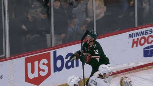 A Hockey Player With The Number 12 On His Jersey Stands On The Ice GIF