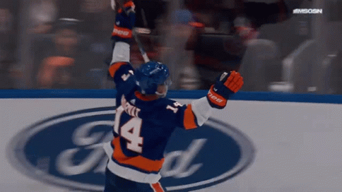 A Hockey Player With The Number 14 On His Jersey Is Celebrating GIF