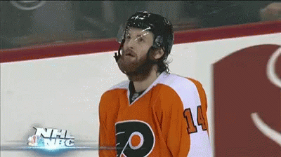 A Hockey Player With The Number 14 On His Jersey Stands On The Ice GIF
