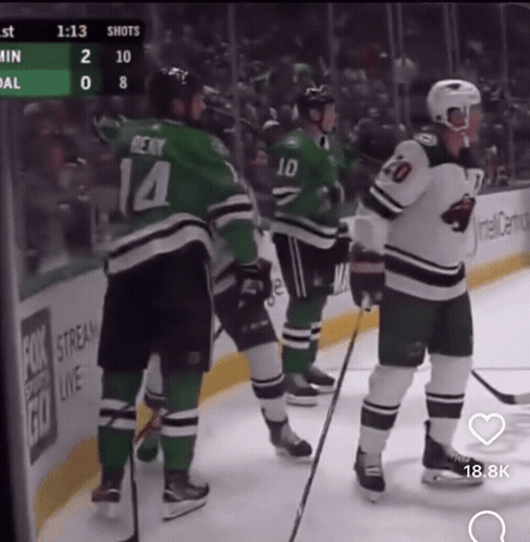 A Hockey Player With The Number 14 On His Jersey Stands On The Ice GIF