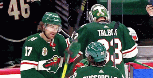 A Hockey Player With The Number 17 On His Jersey Talks To Another Player GIF