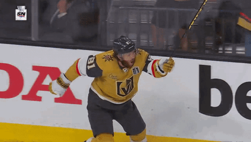 A Hockey Player With The Number 18 On His Jersey Celebrates His Goal GIF