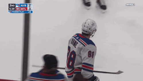 A Hockey Player With The Number 18 On His Jersey Stands On The Ice GIF