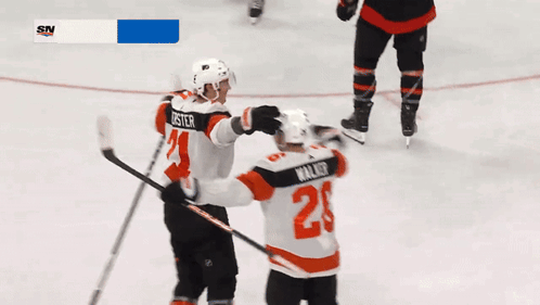 A Hockey Player With The Number 2 On His Jersey Hugging Another Player GIF