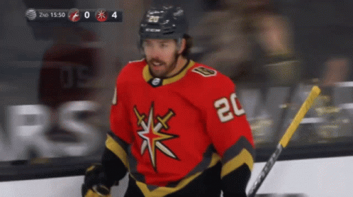 A Hockey Player With The Number 20 On His Jersey Stands On The Ice GIF