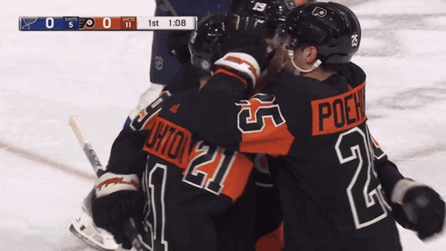 A Hockey Player With The Number 21 On His Jersey Hugs Another Player GIF
