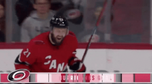 A Hockey Player With The Number 21 On His Jersey Is Holding A Stick GIF