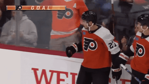 A Hockey Player With The Number 21 On His Jersey Stands On The Ice GIF