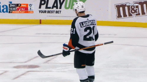 A Hockey Player With The Number 21 On His Jersey Stands On The Ice GIF