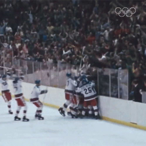 A Hockey Player With The Number 25 On His Jersey Is Surrounded By His Teammates GIF