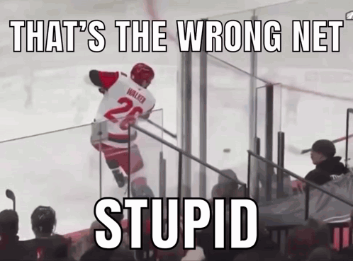 A Hockey Player With The Number 26 On His Jersey Jumps Over A Fence GIF