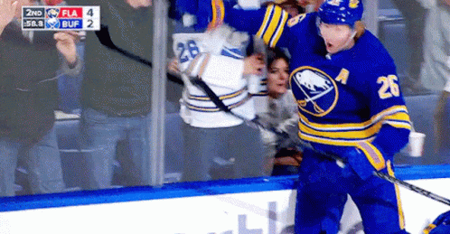 A Hockey Player With The Number 26 On His Jersey Stands On The Ice GIF