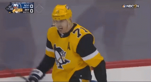 A Hockey Player With The Number 27 On His Jersey Stands On The Ice GIF