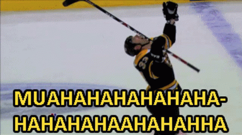 A Hockey Player With The Number 36 On His Jersey Is Holding His Stick In The Air GIF