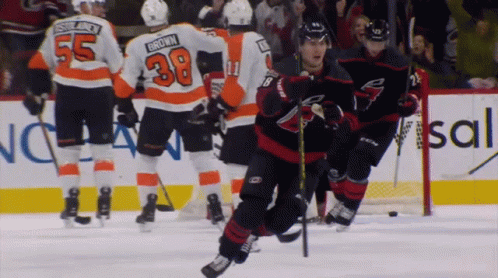 A Hockey Player With The Number 38 On His Jersey Is Skating On The Ice GIF