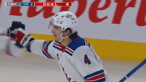 A Hockey Player With The Number 4 On His Jersey Celebrates His Goal GIF