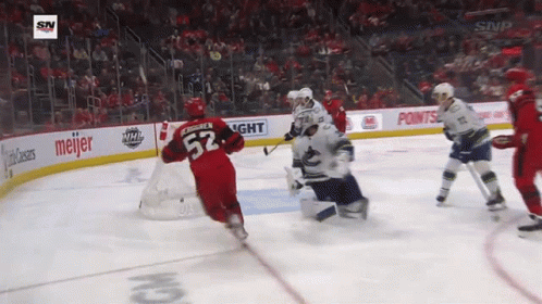 A Hockey Player With The Number 52 On His Jersey Is Skating Around The Ice GIF