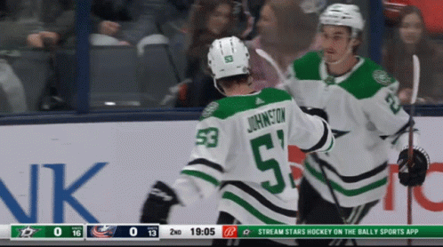 A Hockey Player With The Number 53 On His Back Is Being Hugged By Another Player GIF