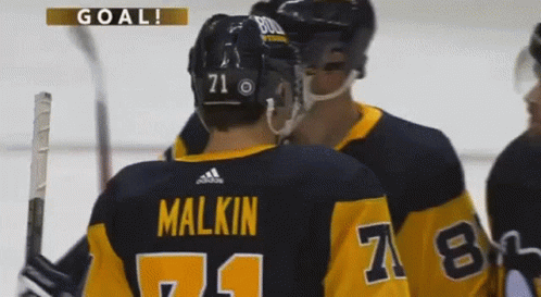 A Hockey Player With The Number 71 On His Back GIF