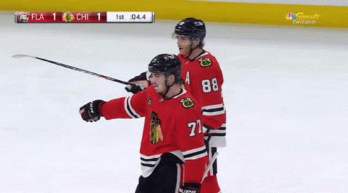 A Hockey Player With The Number 71 On His Jersey Celebrates A Goal GIF