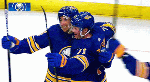 A Hockey Player With The Number 71 On His Jersey Is Hugging Another Player GIF