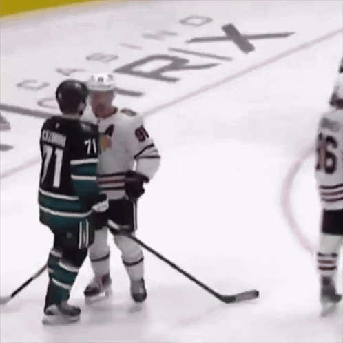 A Hockey Player With The Number 71 On His Jersey Talks To Another Player GIF