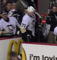 A Hockey Player With The Number 71 On His Shirt GIF