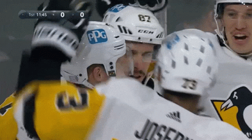 A Hockey Player With The Number 82 On His Helmet Is Surrounded By Other Players GIF