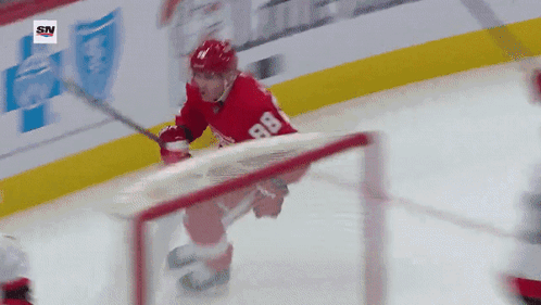 A Hockey Player With The Number 88 On His Jersey Is Skating On The Ice GIF