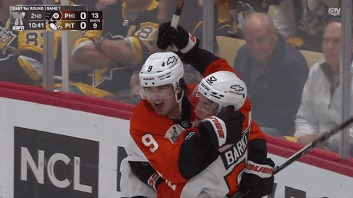 A Hockey Player With The Number 9 On His Jersey Celebrates With Another Player GIF