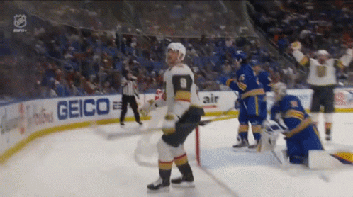 A Hockey Player With The Number 9 On His Jersey Stands On The Ice GIF
