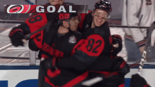 A Hockey Player With The Number 92 On His Jersey Is Hugging Another Player GIF