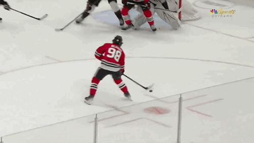 A Hockey Player With The Number 98 On His Back GIF