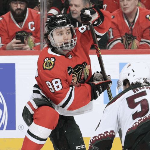 A Hockey Player With The Number 98 On His Shirt GIF
