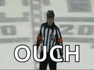 A Hockey Referee Is Standing On The Ice With The Word Ouch In Front Of Him GIF