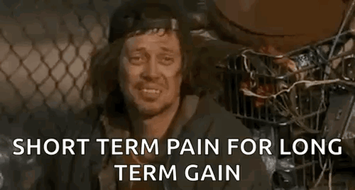 A Homeless Man Is Sitting In A Cage With The Words `` Short Term Pain For Long Term Gain '' Written Above Him . GIF