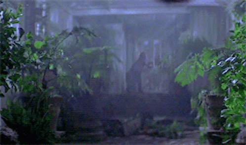 A Hook Is Hanging From A Ceiling In The Dark GIF
